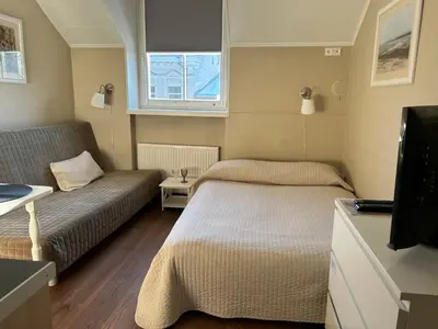 a small room with two beds and a couch at G-45 in Vilnius