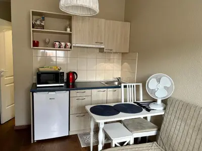 a small kitchen with a table and a microwave at G-45 in Vilnius