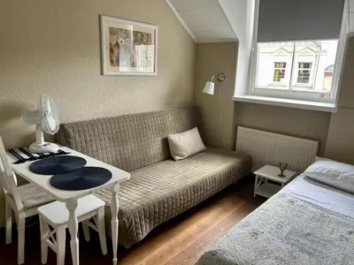 a living room with a couch and a table and a bed at G-45 in Vilnius