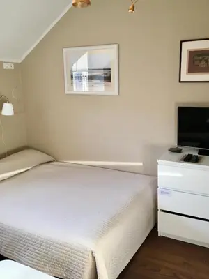 a bedroom with a bed and a flat screen tv at G-45 in Vilnius