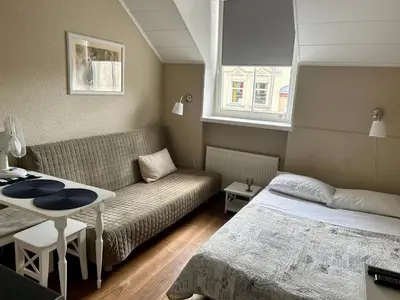 a room with a bed and a couch and a table at G-45 in Vilnius