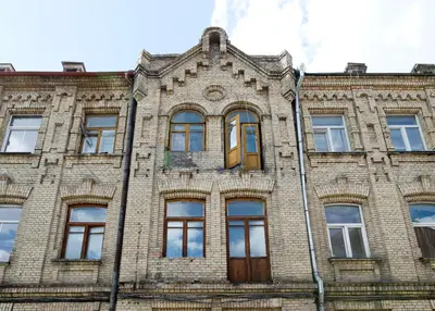 an old brick building with a brown door and windows at Cozy studio in Old Town by URBAN RENT in Vilnius