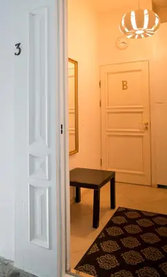 a room with a door and a bench and a table at Cozy studio in Old Town by URBAN RENT in Vilnius