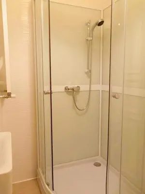 a shower with a glass door in a bathroom at Cozy studio in Old Town by URBAN RENT in Vilnius