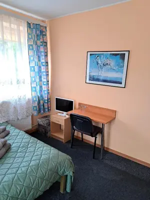 a hotel room with a desk and a bed at Jeruzale Hotel in Vilnius