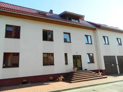 a white building with stairs and a door at Jeruzale Hotel in Vilnius