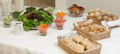 a table topped with baskets of food and bowls of food at Royal SPA Residence in Birštonas