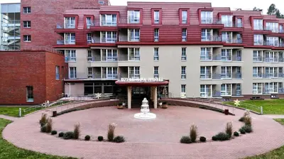 a building with a fountain in front of a building at Royal SPA Residence in Birštonas