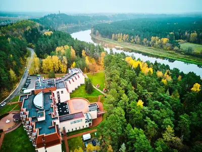 an aerial view of a building next to a river at Royal SPA Residence in Birštonas