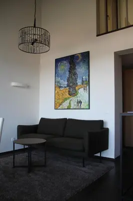 a living room with a couch and a painting on the wall at Margis Hotel & SPA in Trakai