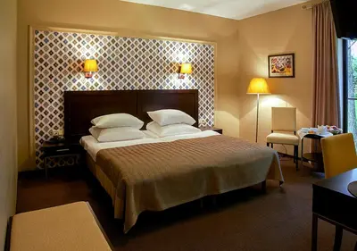 a bedroom with a large bed with two pillows at Margis Hotel & SPA in Trakai