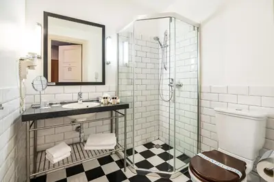 a bathroom with a shower and a toilet and a sink at VICTORIA Hotel Kaunas in Kaunas