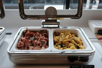 a tray of food in a container on a table at AIRINN Vilnius Airport Hotel RENOVATED 2025 in Vilnius