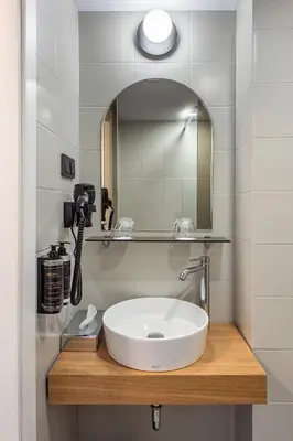 a bathroom with a sink and a mirror at AIRINN Vilnius Airport Hotel RENOVATED 2025 in Vilnius