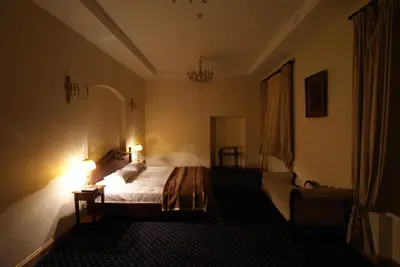 a bedroom with a bed and a chair and lights at Bistrampolis Manor in Kučiai