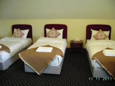 a hotel room with two beds in a room at Bistrampolis Manor in Kučiai