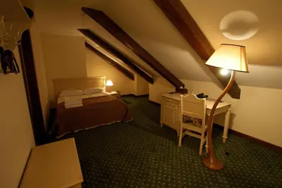 a bedroom with a bed and a desk with a lamp at Bistrampolis Manor in Kučiai