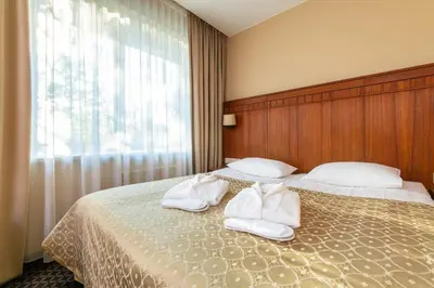 a hotel room with two beds with white towels at Grand SPA Lietuva Hotel Druskininkai in Druskininkai