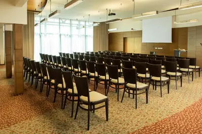 a row of chairs in a room with a screen at Grand SPA Lietuva Hotel Druskininkai in Druskininkai