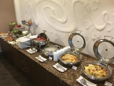 a buffet with many plates of food on a counter at Grand SPA Lietuva Hotel Druskininkai in Druskininkai