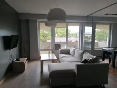 a living room with a couch and a piano at Central Druskininkai Apartment in Druskininkai
