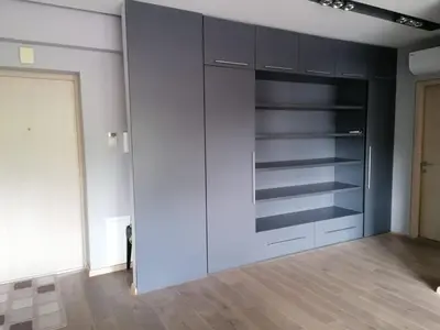 a room with a closet with black and white cabinets at Central Druskininkai Apartment in Druskininkai