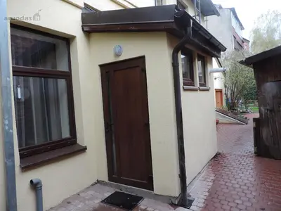 a house with a brown door on the side of it at Giedres Old town studio in Kaunas