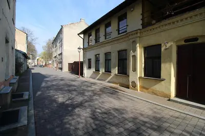 an empty street in a city with buildings at Giedres Old town studio in Kaunas
