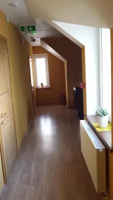 an empty room with a hallway with a window at Apartamentai 