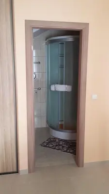 a bathroom with a shower with a glass door at Apartamentai 