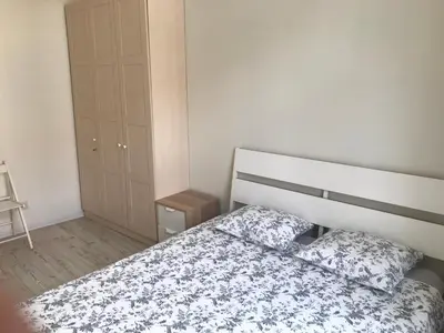a bedroom with a bed with a floral bedspread at Igo apartment Uzupis in Vilnius