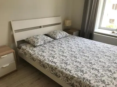 a bedroom with a bed with a floral bedspread at Igo apartment Uzupis in Vilnius