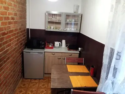 a small kitchen with a table and a refrigerator at 