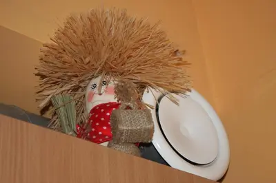 a snow man sitting on top of a table with a plate at Prie Miesto Vartų in Vilnius