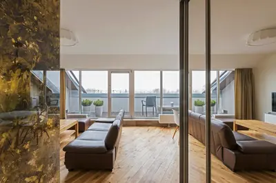 a living room with a couch and a table at Napoleon Hill Apartment in Kaunas
