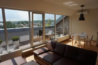 a living room with a couch and a table at Napoleon Hill Apartment in Kaunas