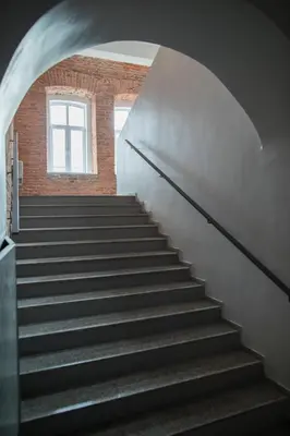 a staircase in a building with a window at Napoleon Hill Apartment in Kaunas