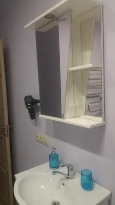 a bathroom with a white sink and a mirror at Šeimyninis butas in Birštonas