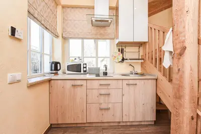 a kitchen with a sink and a microwave at Manto Apartamentai in Druskininkai