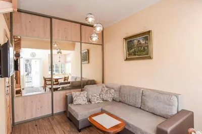a living room with a couch and a table at Manto Apartamentai in Druskininkai