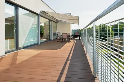a balcony of a building with a table and chairs at Central Apartment in Birštonas