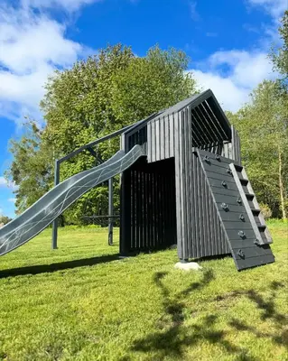 a playground with a slide in a park at Family house in Druskininkai