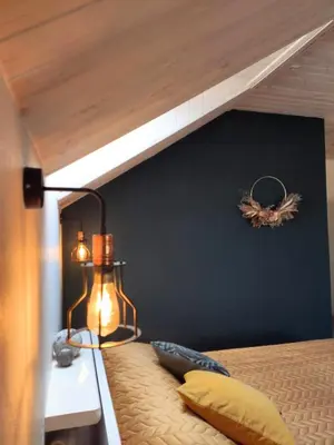 a bedroom with a bed with a wooden ceiling at Family house in Druskininkai