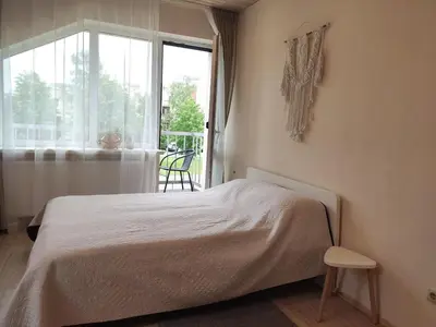 a bedroom with a bed and a window at Family house in Druskininkai
