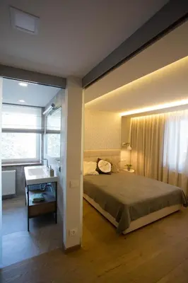 a bedroom with a bed and a desk and a window at Angel in Druskininkai