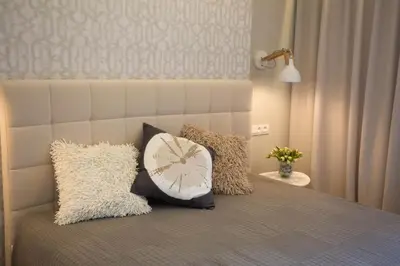 a bedroom with a bed with pillows on it at Angel in Druskininkai