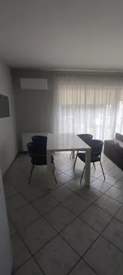 a living room with a table and chairs and a couch at Apartments near old town with private parking in Kaunas