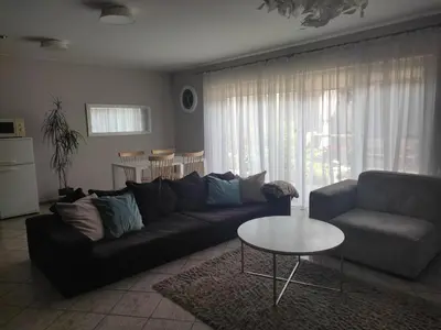 a living room with a couch and a table at Apartments near old town with private parking in Kaunas