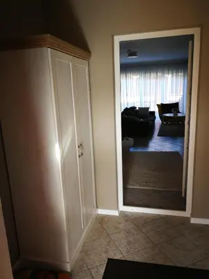 a hallway with a door to a living room at Apartments near old town with private parking in Kaunas