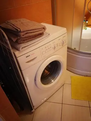 a washing machine with towels on top of it at Apartments near old town with private parking in Kaunas